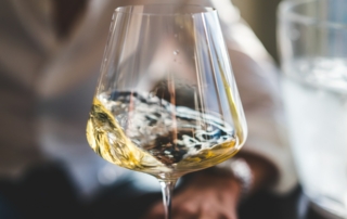 Champagne swirling in a glass during a sommelier class.